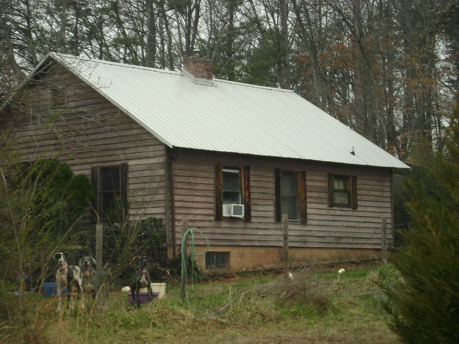 White metal roof on an old wood sided farmhouse, from a Asphalt Shingle Roof Repair job in Prospect Park